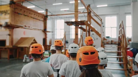 A team of children in protective helmets begins an extreme test Stock Footage 276489341