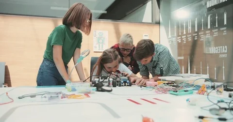 A team of children is working in the office. Discuss new toy development. Pour a Stock Footage 80990291