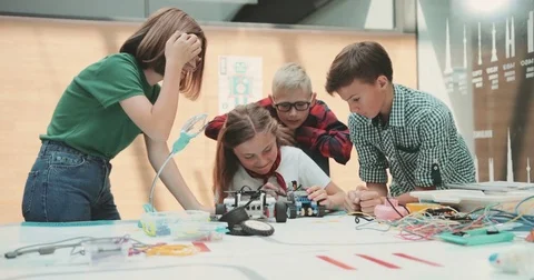 A team of children is working in the office. Discuss new toy development. Pour a Video stock 80990586