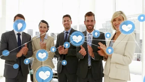 Team clapping for launch blue heart icon popping and moving forming health Stock Footage 333904579