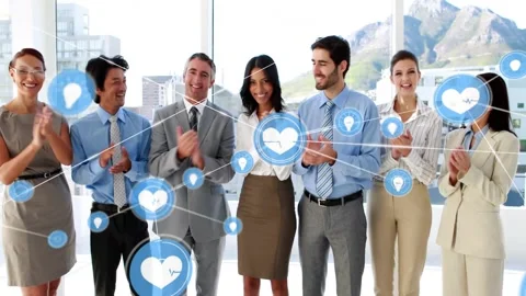 Team clapping in office, sparking blue heart node network growing toward lens Stock Footage 333833485