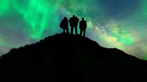 The team climbed to the top of the mountain and looked up at the stars Stock Footage 288093949