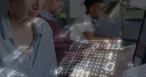 Team coding software on monitors in tech office, with glowing binary code and Stock Footage 308658241