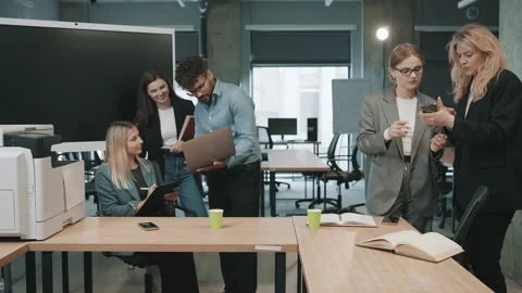 Team collaborates in modern office space to review documents Stock Footage 312258387