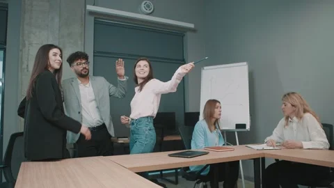 Team collaborates in modern office space discussing project details Stock Footage 318524134