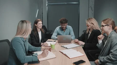 Team collaborates in office meeting with focused discussions and document Video stock 312257683