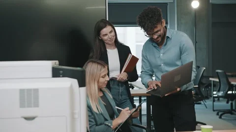 Team collaborates in office setting with slow motion document handling Video stock 312258225