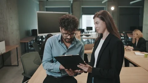 Team collaborates in office space with slow motion document review Video stock 312258682