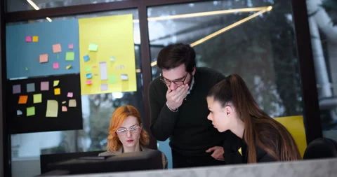 Team collaborates on project in office with sticky notes on the wall during Stock Footage 338358965