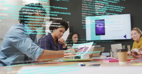 Team collaborating around conference table, reviewing software code overlay and Video stock 308677872