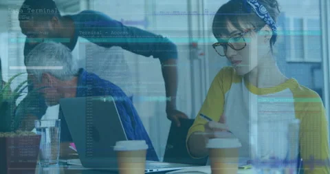 Team collaborating around table with laptops, displaying floating coding windows Stock Footage 309098278