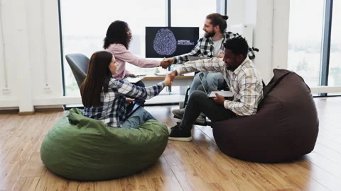 Team collaborating on artificial intelligence project in a modern office setting Stock Footage 318206598