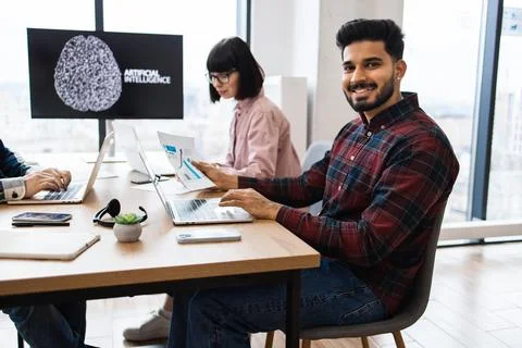 Team collaborating on artificial intelligence project in modern office Stock Photos