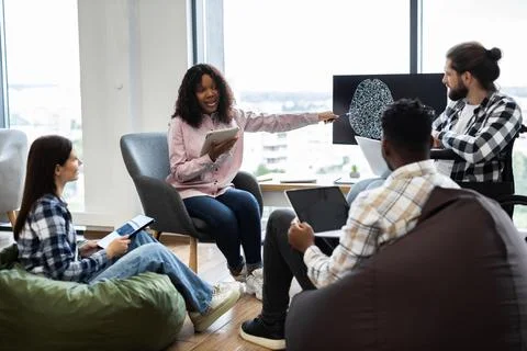 Team collaborating on artificial intelligence project in office Stock Photos