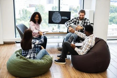 Team collaborating on artificial intelligence project in a modern office setting 写真素材