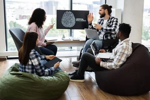 Team collaborating on artificial intelligence project in modern office setting Stock Photos