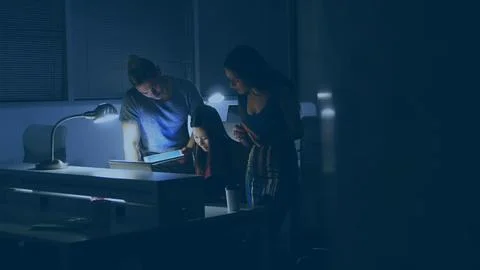 Team is collaborating on laptop, tablet, coffee mug with lamps in flat design Stock Photos