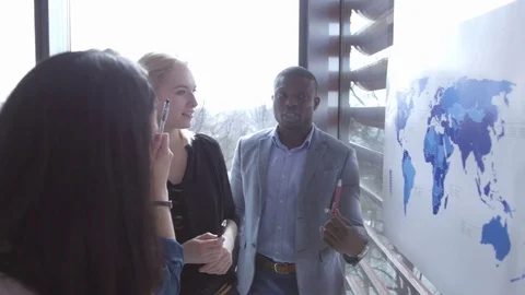 Team collaborating organizing an international project at the office Stock Footage 73870151