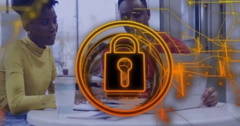 Team collaborating over laptop, showing holographic padlock with circuit pattern Stock Footage 307432394