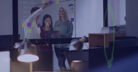 Team collaborating on project with data visualization image over office Stock Photos