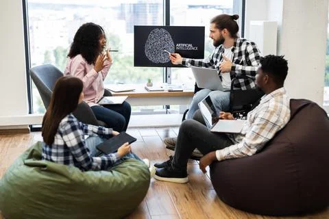 Team collaboration on artificial intelligence project in office environment Stock Photos