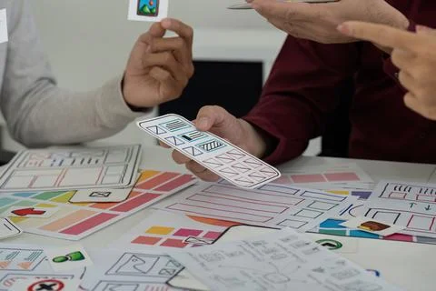 Team Collaboration in UI Design. Collaborators brainstorming and refining user Foto stock