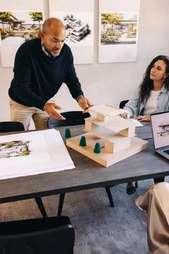 Team collaboratively discussing architectural plans and construction projec.. Stock Photos