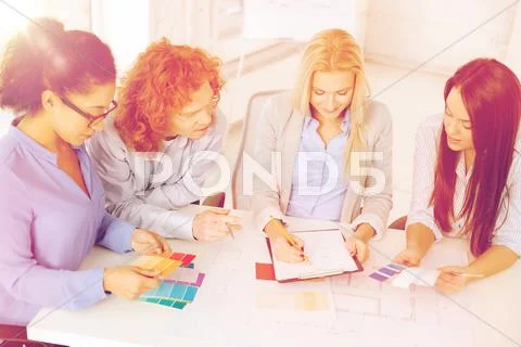 Team with color samples and blueprint at office Stock Photos