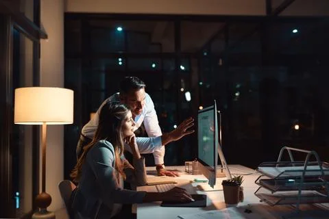 Team commitment gets results. a businessman and businesswoman using a computer Stock Photos