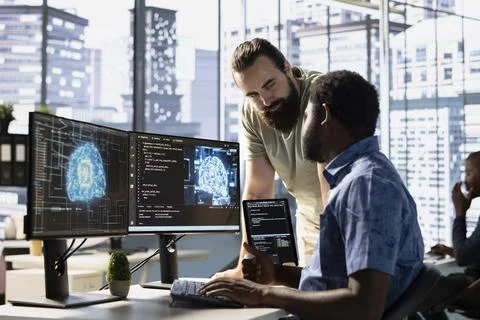 Team of computer scientists checking AI code, doing brainstorming Stock Photos