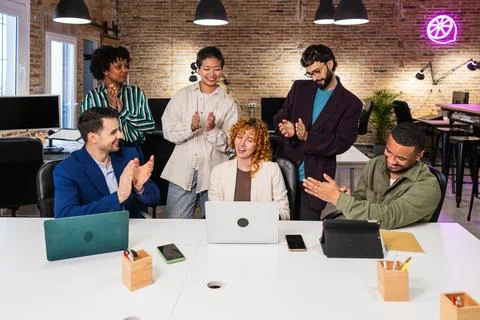 Team congratulating project manager clapping in modern office Stock Photos