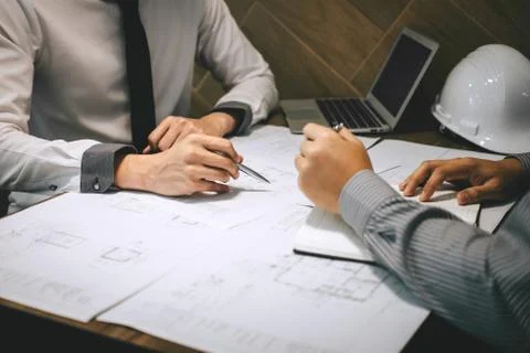 Team of construction engineering or architect partner discuss a blueprint whi Stock Photos