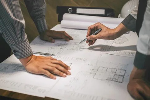 Team of construction engineering or architect partner discuss a blueprint whi Stock Photos