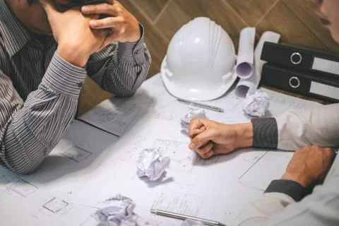 Team of construction engineering or architect partner discuss a blueprint whi Stock Photos