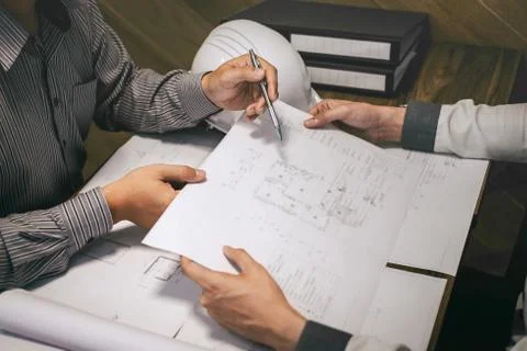 Team of construction engineering or architect partner discuss a blueprint whi Stock Photos