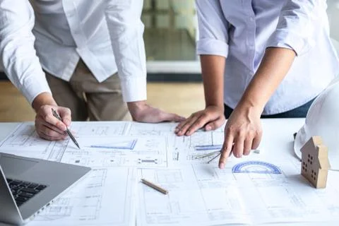 Team of construction engineering or architect partner discuss a blueprint whi Stock Photos