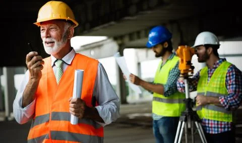 Team of construction engineers, architects working on building site Fotos de archivo