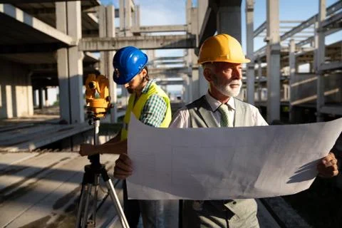 Team of construction engineers, architects working on building site Fotos de archivo