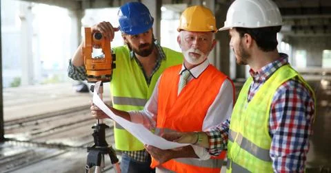 Team of construction engineers, architects working on building site Fotos de archivo
