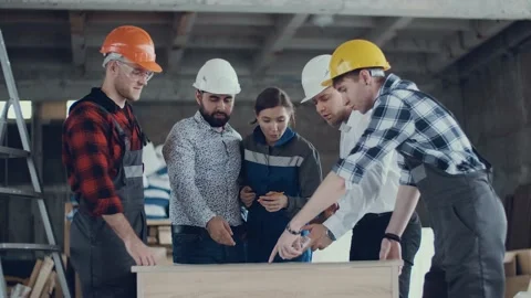 Team of construction engineers are studying a work plan at a construction site Stock Footage 131694007