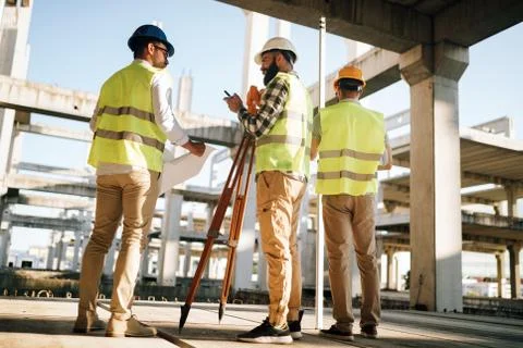 Team of construction engineers working on building site Fotos de archivo
