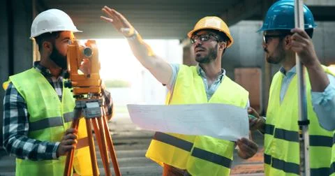 Team of construction engineers working on building site Fotos de archivo