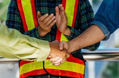 Team of construction worker shaking hand with customer Stock Photos