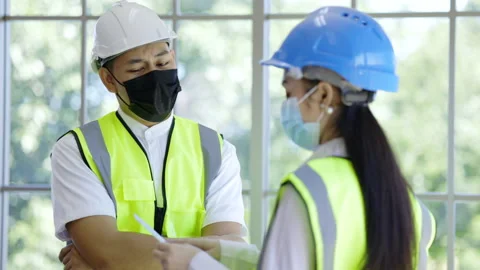 Team of construction workers talking giving advice on vaccination against COVID Stock Footage 156859142