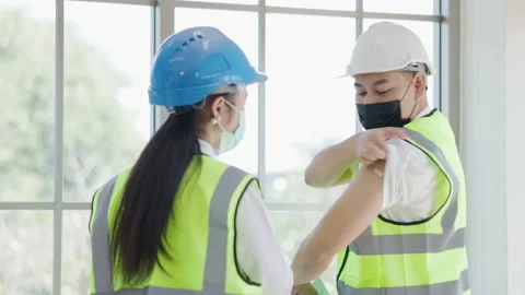 Team of construction workers talking giving advice vaccination against COVID19 Stock Footage 157772418