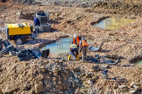 Team of construction workers working on building site Stock Photos
