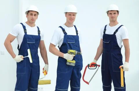 Team of construction workers with working tools Foto stock