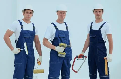 Team of construction workers with working tools Foto stock