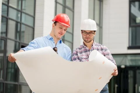 Team of constructors are working according the plan and scheme Stock Photos