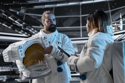 Team of cosmonauts doing brainstorming, preparing for planetary mission Stock Photos